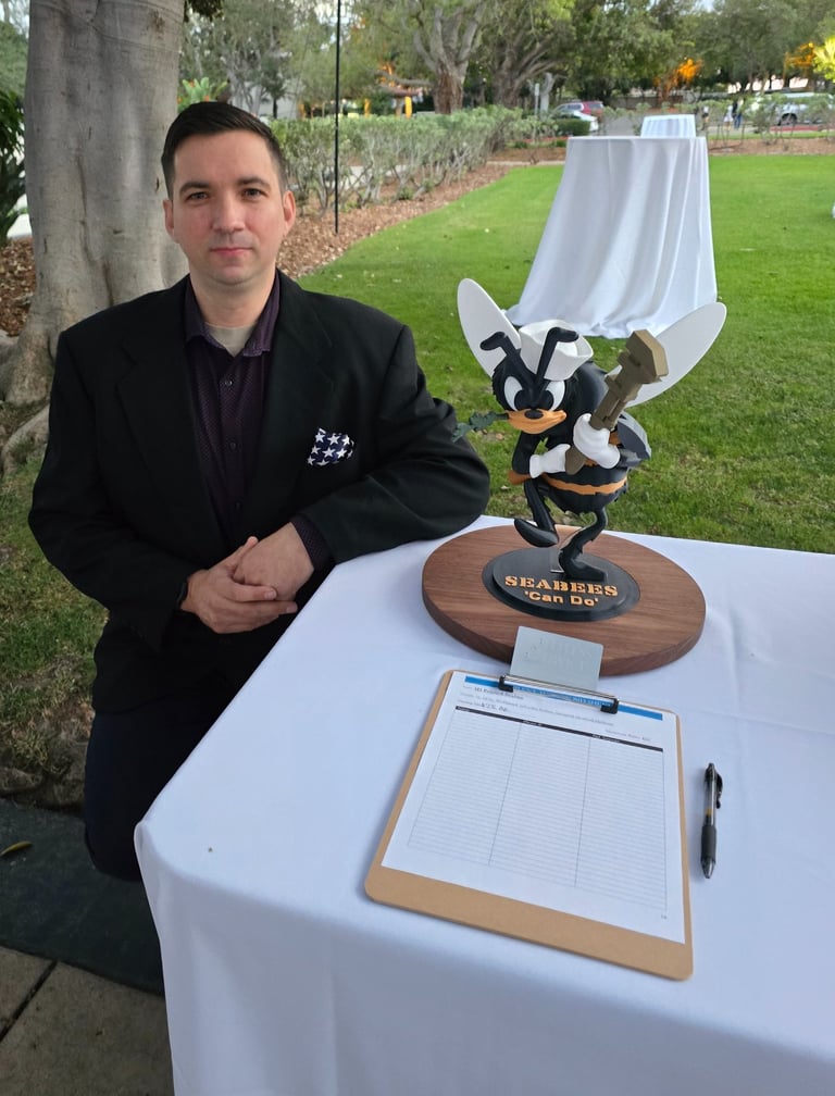 Our founder, next to a donated statue up for auction, with proceeds going to the annual Seabee Ball