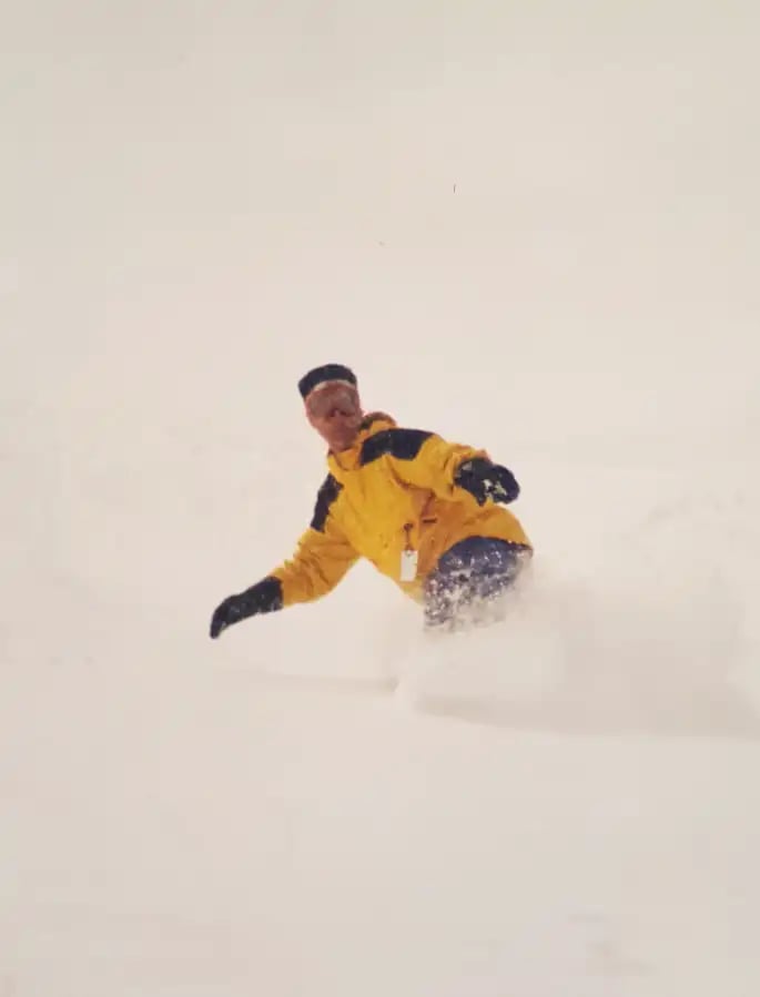 Kyle Keehan snowboarding in deep powder during winter conditions
