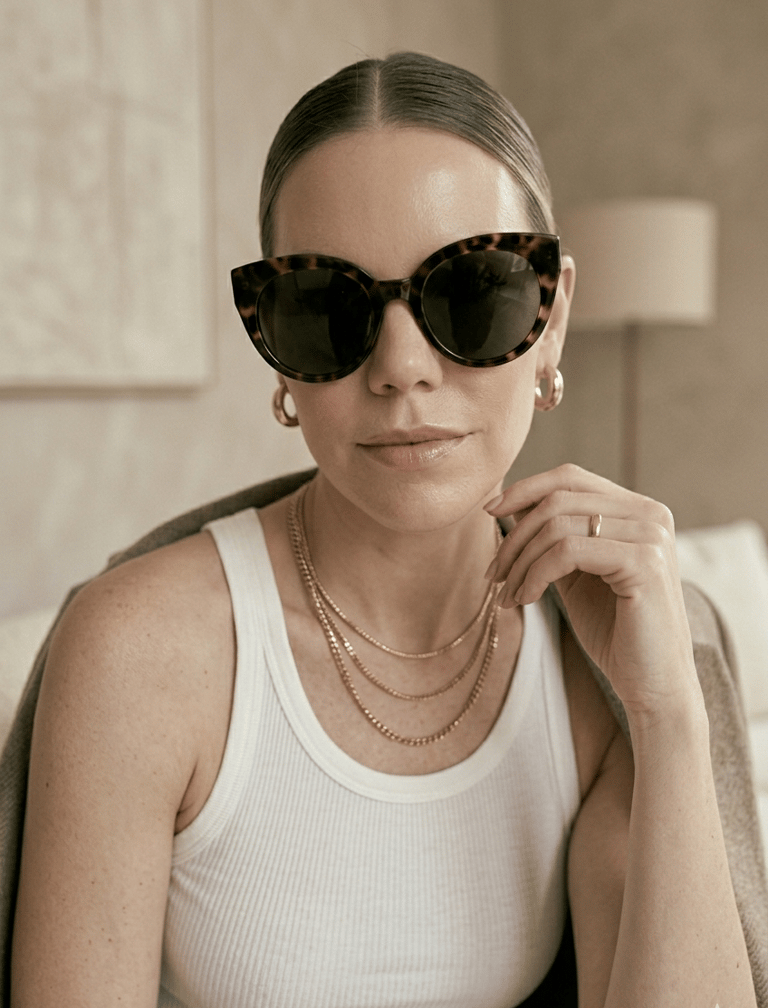 Minimal gold jewelry and sunglasses styled with clean girl fashion essentials