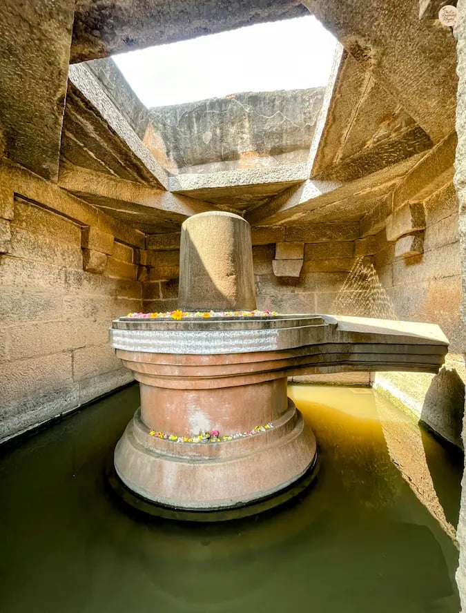 Badavalinga in Hampi, a sacred Shivalinga surrounded by water.