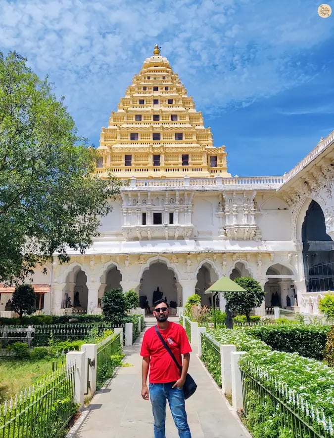 Visitor posing in front of the historic arsenal at Thanjavur Palace, Tamil Nadu