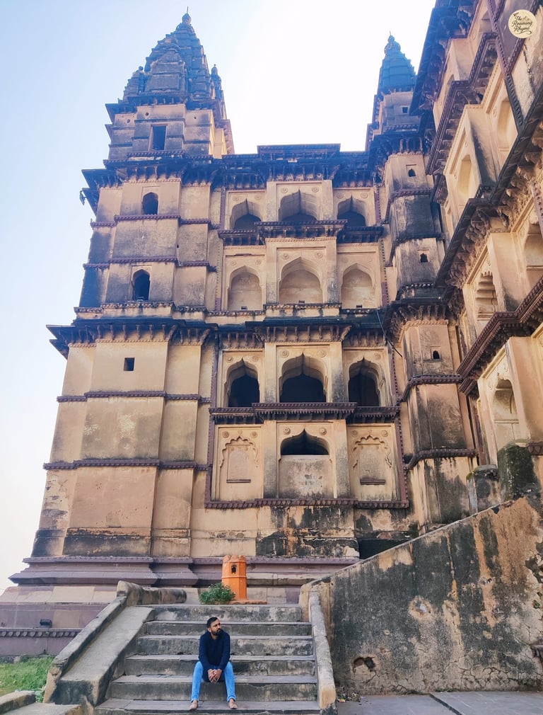 Sitting on the steps of Chaturbhuj Temple, Orchha - capturing its towering beauty.