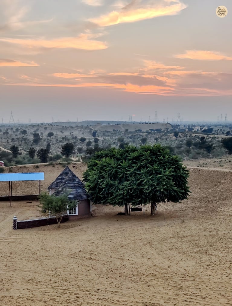 Raisar dunes blush in sunset's hue - Bikaner's golden hush in every view.