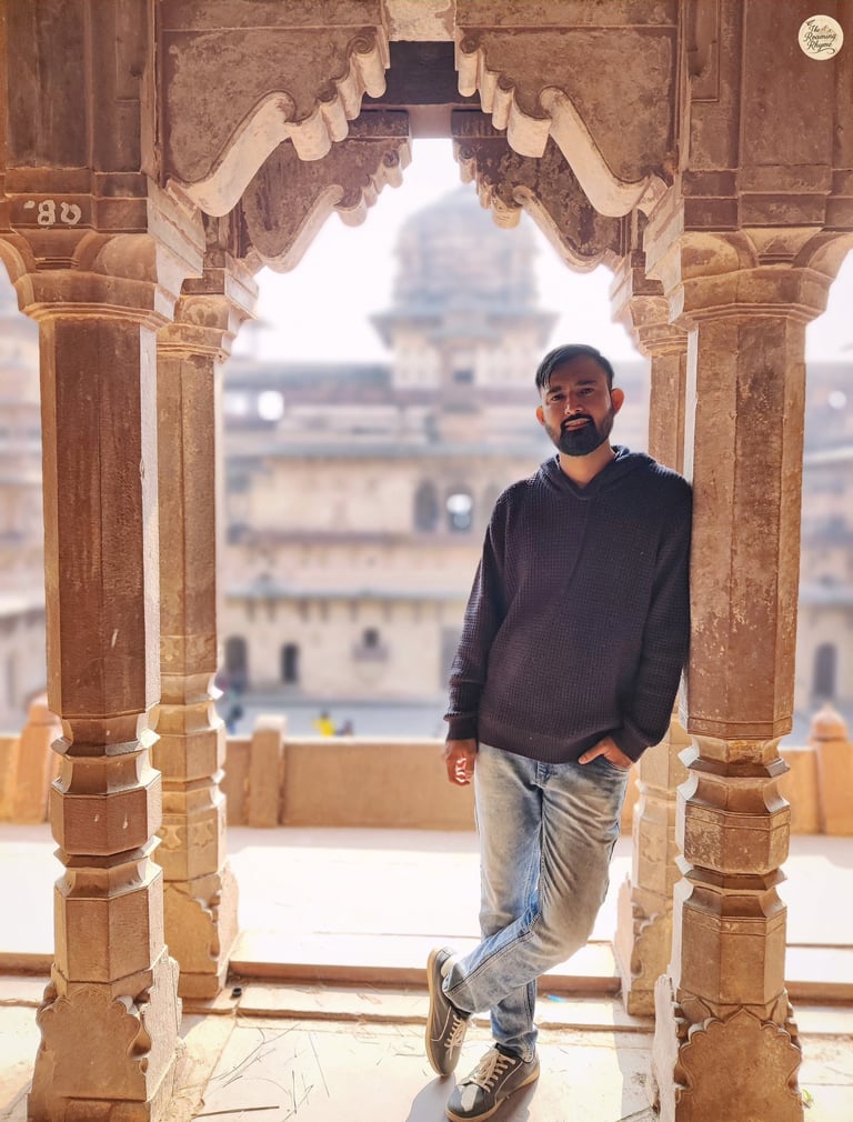 By the arches of Jahangir Mahal's grand courtyard, Orchha