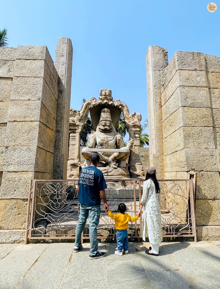 With Lakshmi Narasimha—family moments beside divine strength in stone.