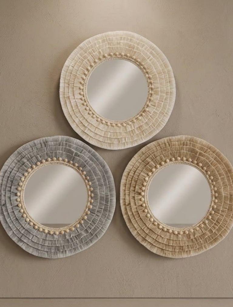 Three handcrafted cotton mirrors arranged as elegant wall art, featuring natural textures and warm b