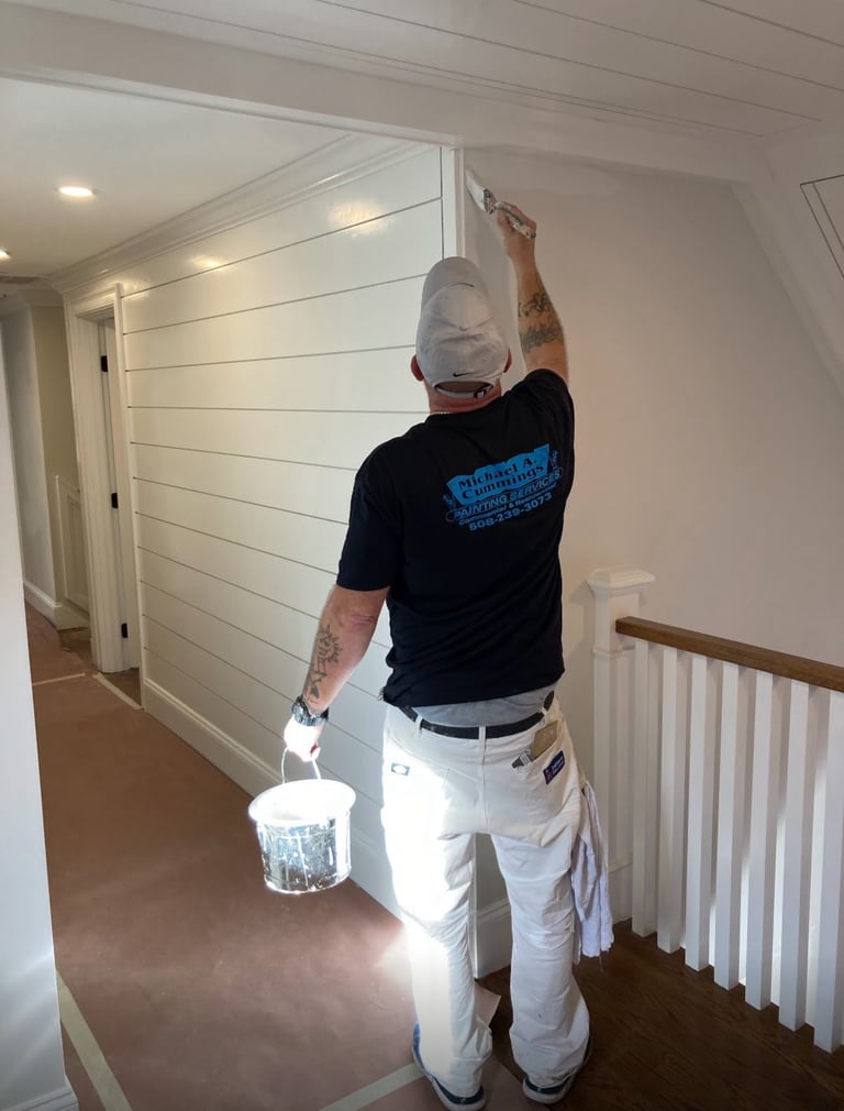 Michael Cummings painting interior walls in Duxbury, MA home using professional brushstrokes