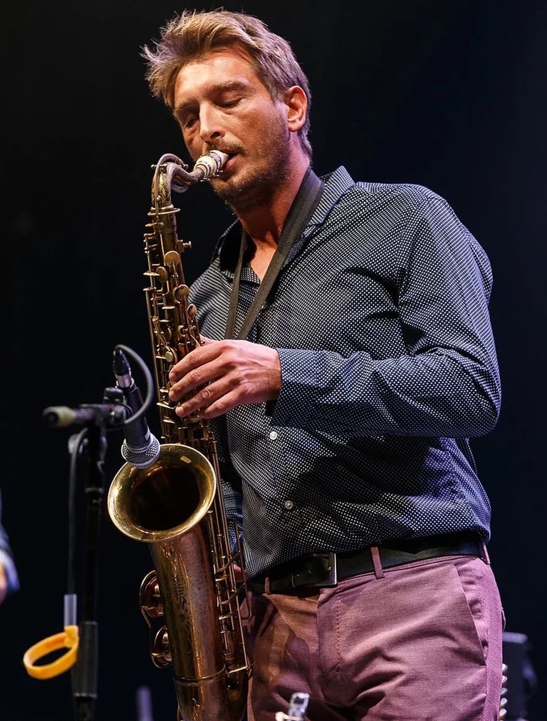 a man playing a saxophone and saxophone