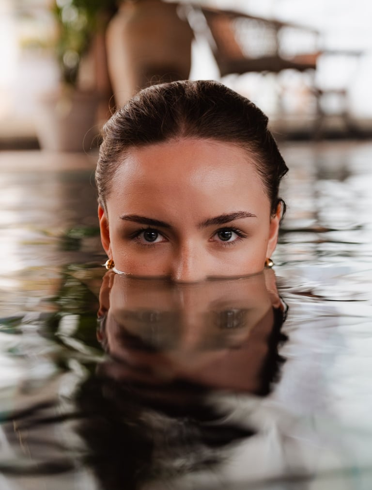 Women in pool with reflections from the water