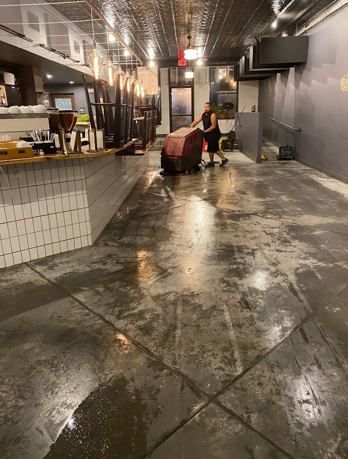 CONCRETE STAINING PROFESSIONAL WORKING IN A BUSINESS