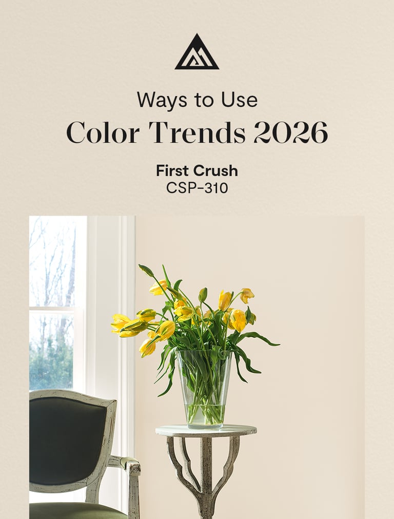 Yellow tulips in a glass vase against a beige First Crush paint color wall for 2026 interior trends.