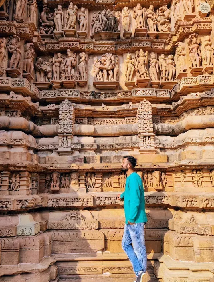 Carvings on Lakshmana Temple, Khajuraho, showing deities, erotic figures, and daily life scenes.