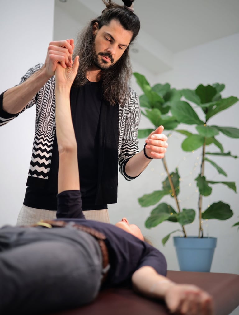 practitioner moving clients outstretched arm to change neurons through inactive movement