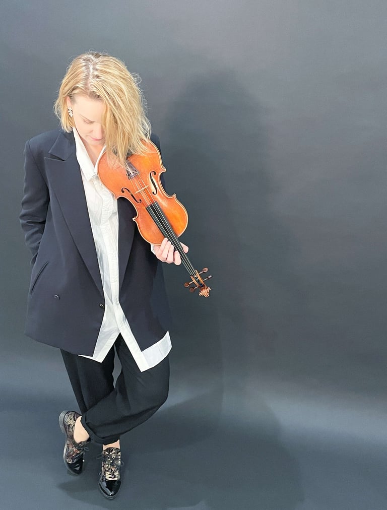 Contemporary portrait of violinist Zydre holding a violin, interdisciplinary classical music artist