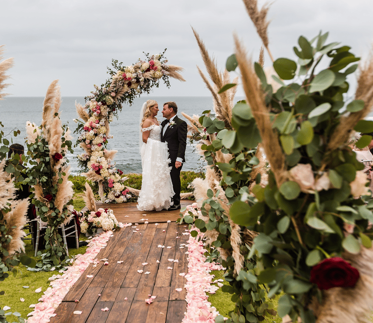 wedding at cuvier park with bride and groom on deck surrounded by flowers