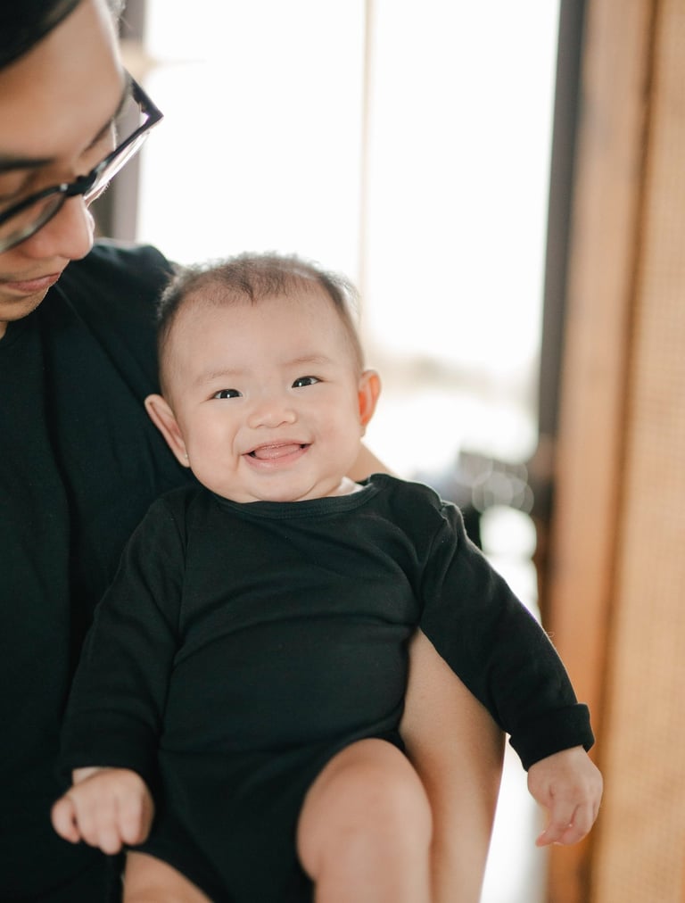 Parents playing with baby during a family photography session at a private villa in Ubud Bali.