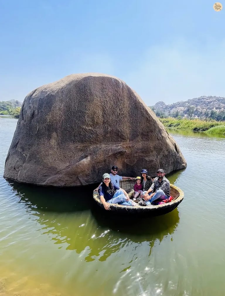 Person sailing on a coracle at Sanapur Lake, Hampi, enjoying the serene waters.