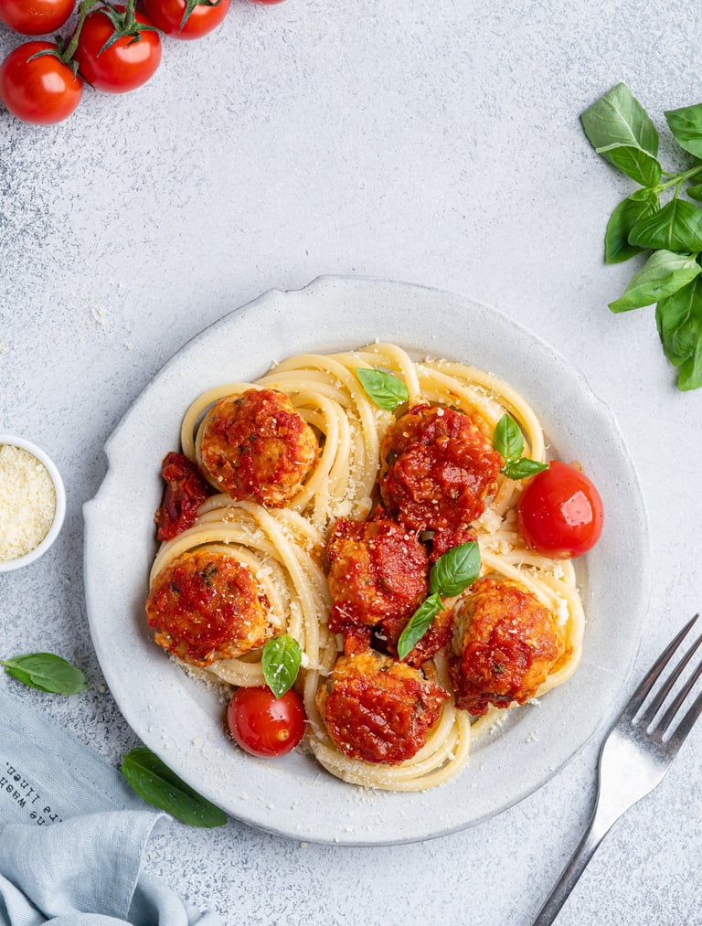 spaghetti with meatballs and cherry tomatoes and parmesan cheese 