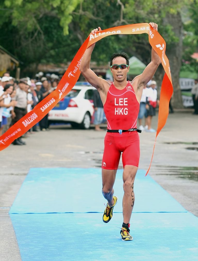 Photo of Daniel Lee, Hong Kong triathlete, crossing the finish line at the Bali 2008 triathlon