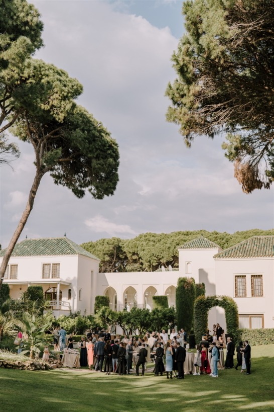 Garden event at Villa El Rincon with guests gathered among lush greenery