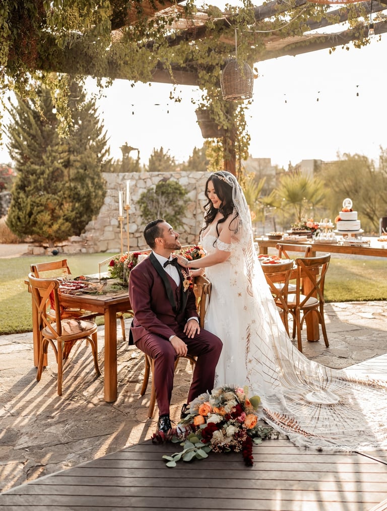 a bride and groom sitting on a deck deck