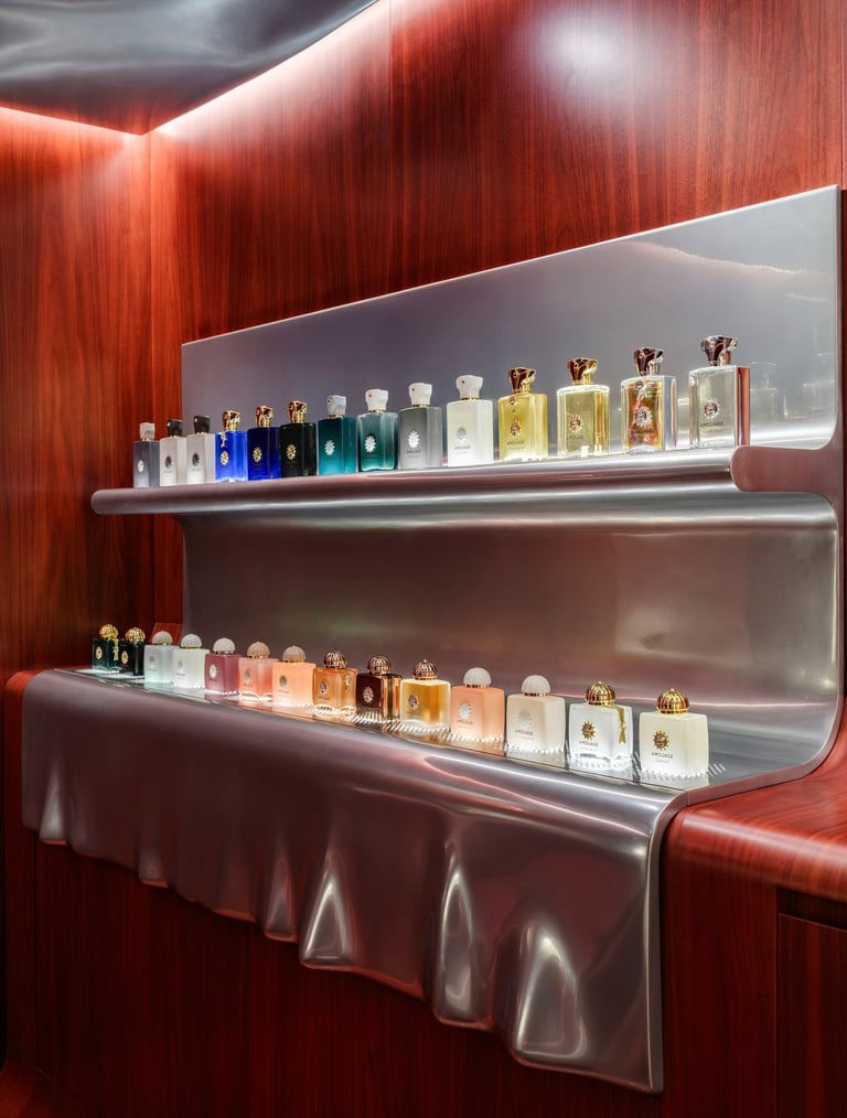 Amouage perfume collection displayed on shelves.