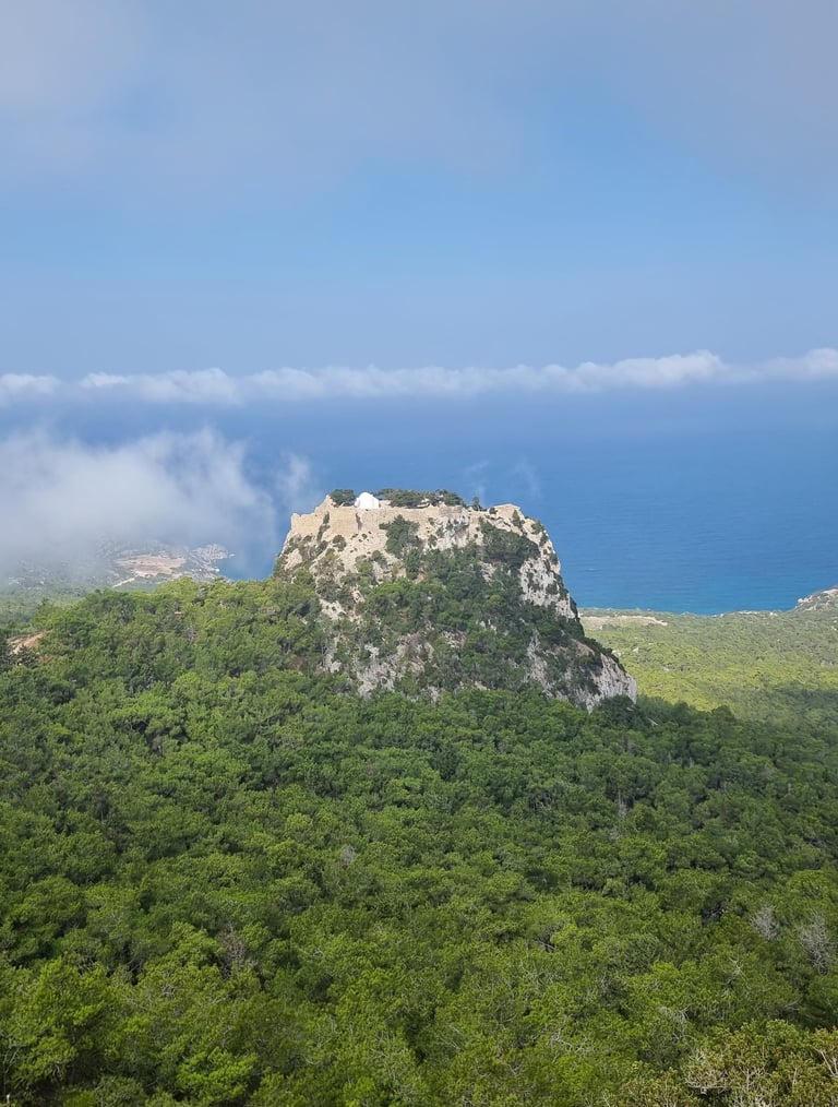 Medieval Monolithos castle on a rocky peak overlooking the Aegean Sea in Rhodes, Greece.