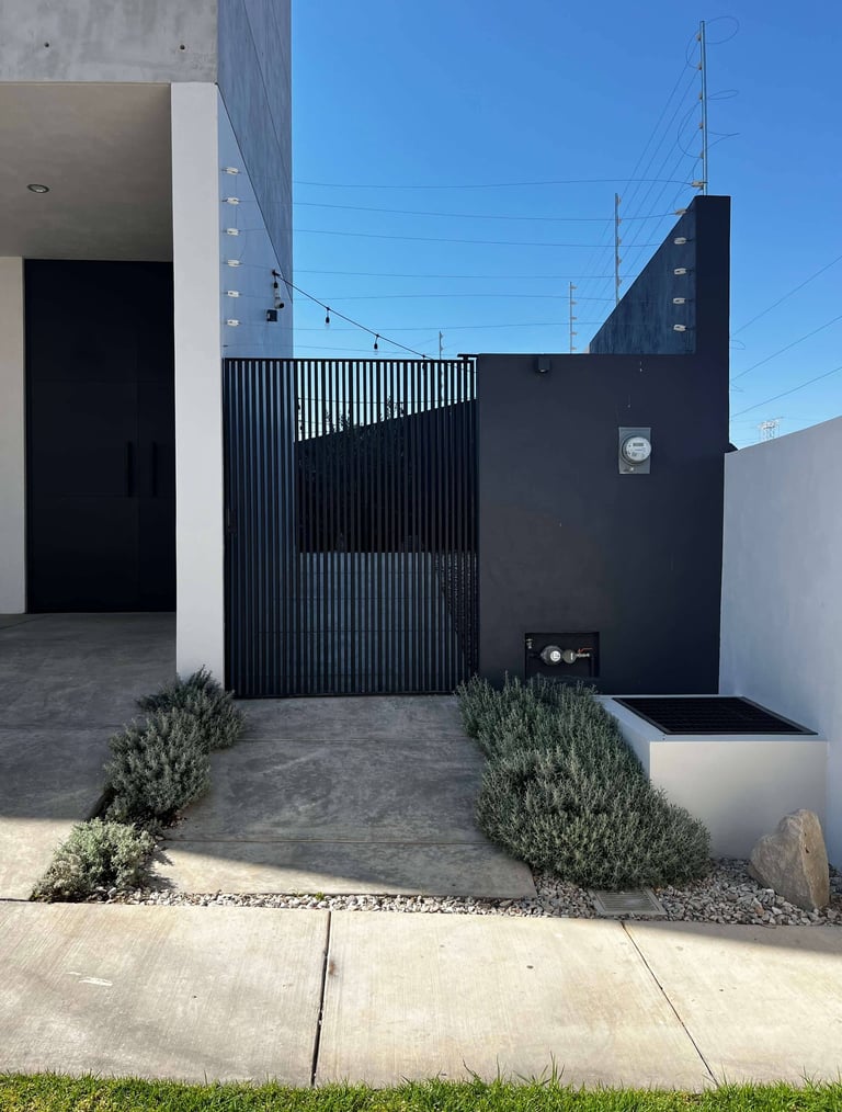 a black and white house with a black gate and a black gate