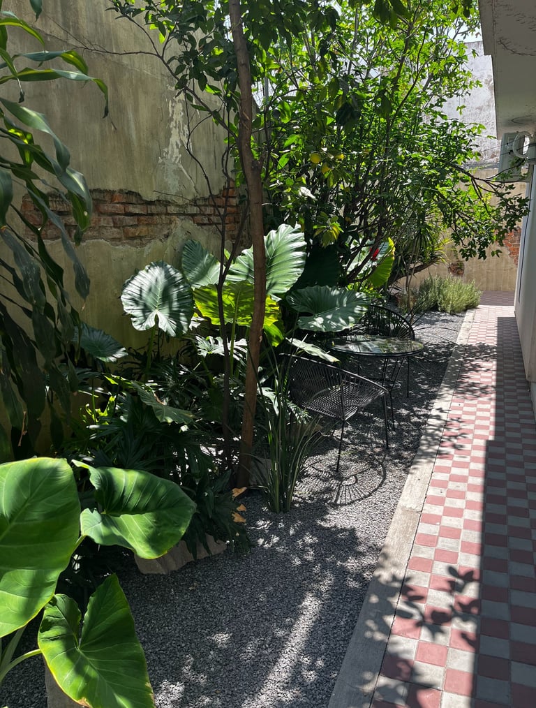 a sidewalk with a bench and a bench in the background