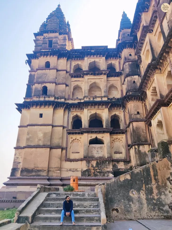 Sitting on the steps of Chaturbhuj Temple, Orchha - capturing its towering beauty.