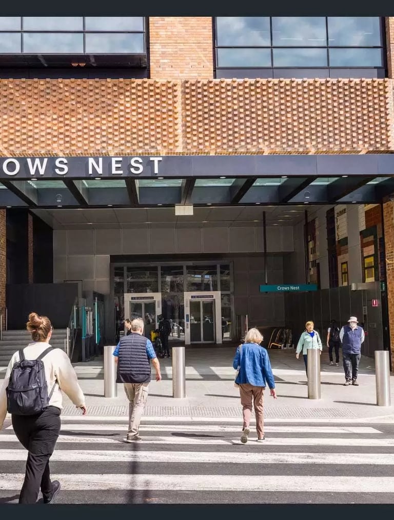 Commuters walking across a Crows Nest Metro entrance