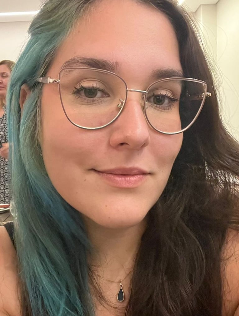 a woman with blue hair and glasses on her face