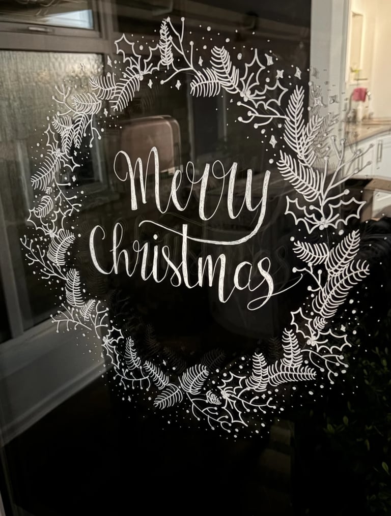 Photographic studio with hand drawn artwork on windows.  Seasonal window art by the letter Jo