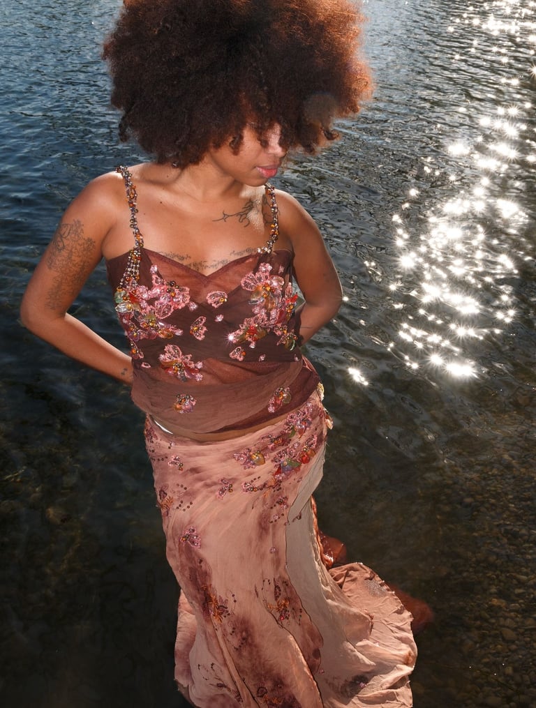 a woman in a dress with a large afro - american afro - american hair