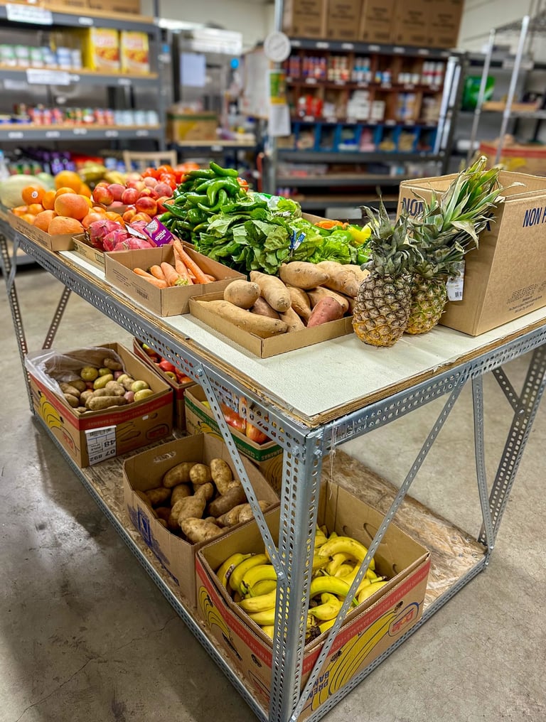 Pantry interior with table of fresh produce and shelves with canned and boxed food