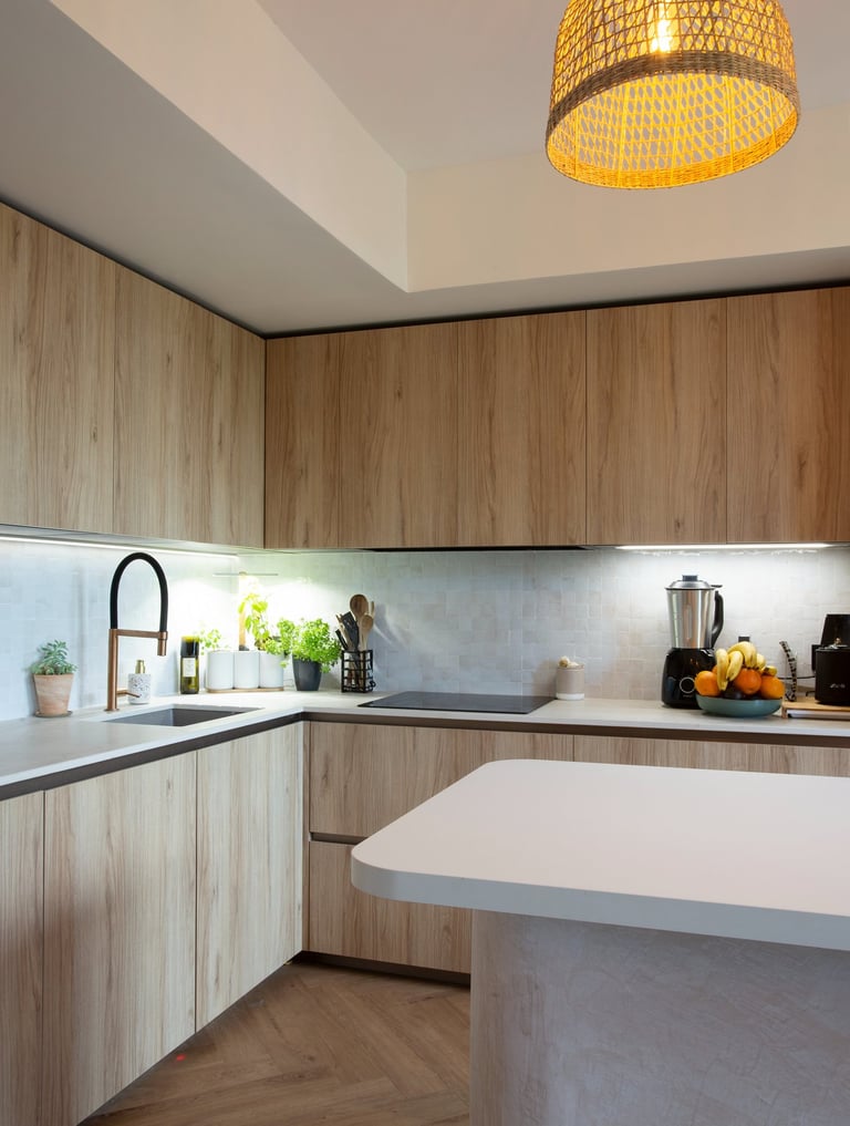 a kitchen with a large light fixture and a wooden floor