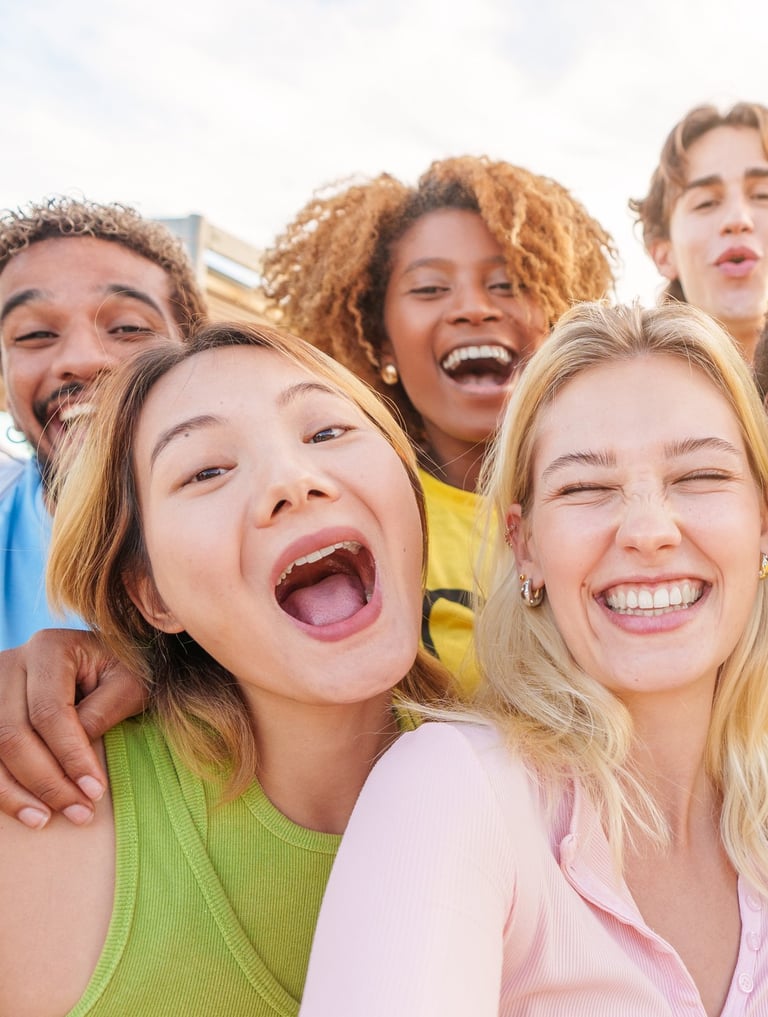 a group of people standing around a woman taking a selfie