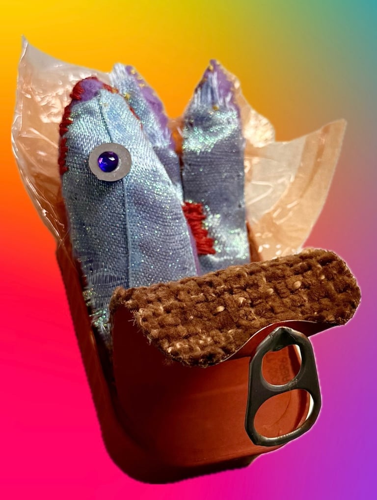 Close-up photo of a sculpture of stitched blue/purple sardine and orange tin with orange foil