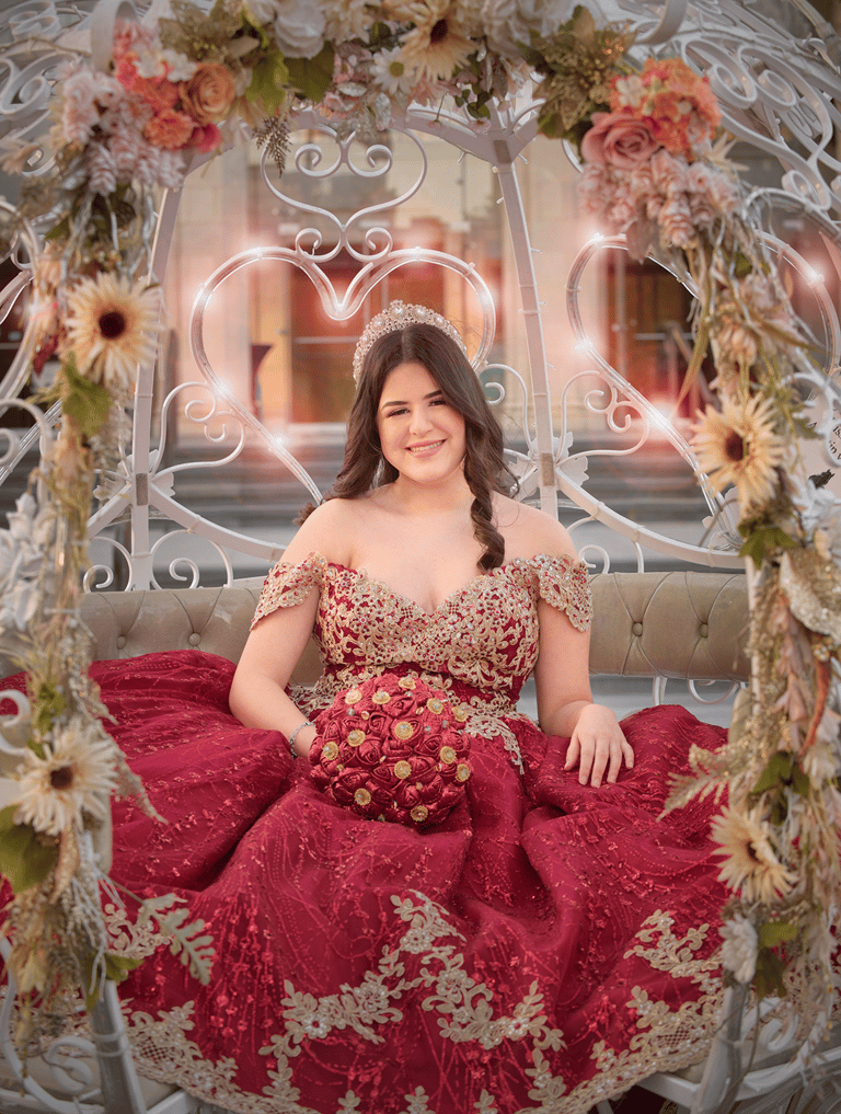 a woman in a red quinceanera dress sitting in a carriage