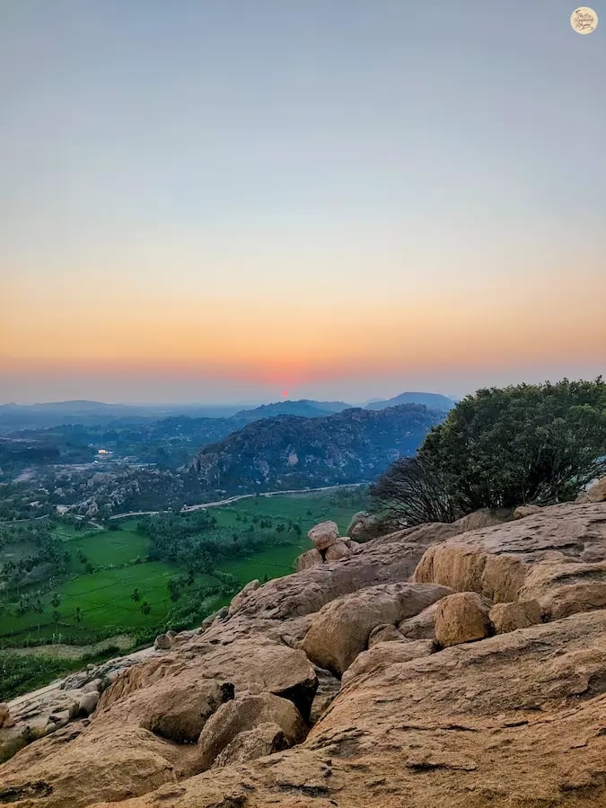 Golden sunrise at Anjanadri Hill in Hampi, marking a peaceful morning.