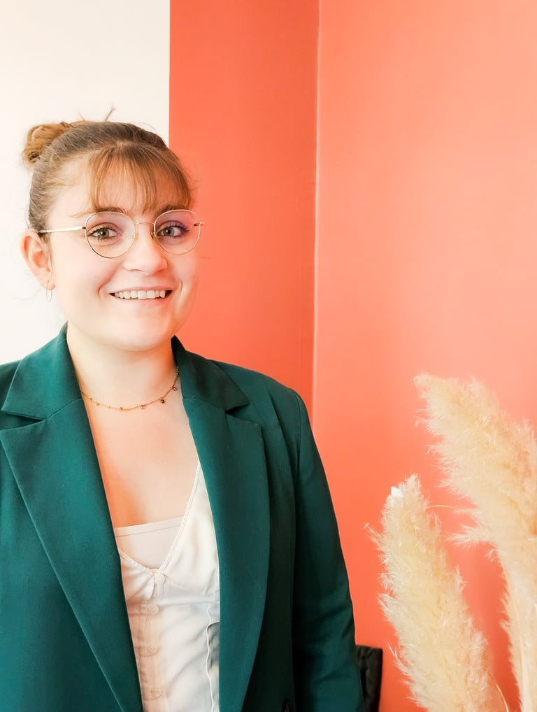 a woman in a green jacket and glasses