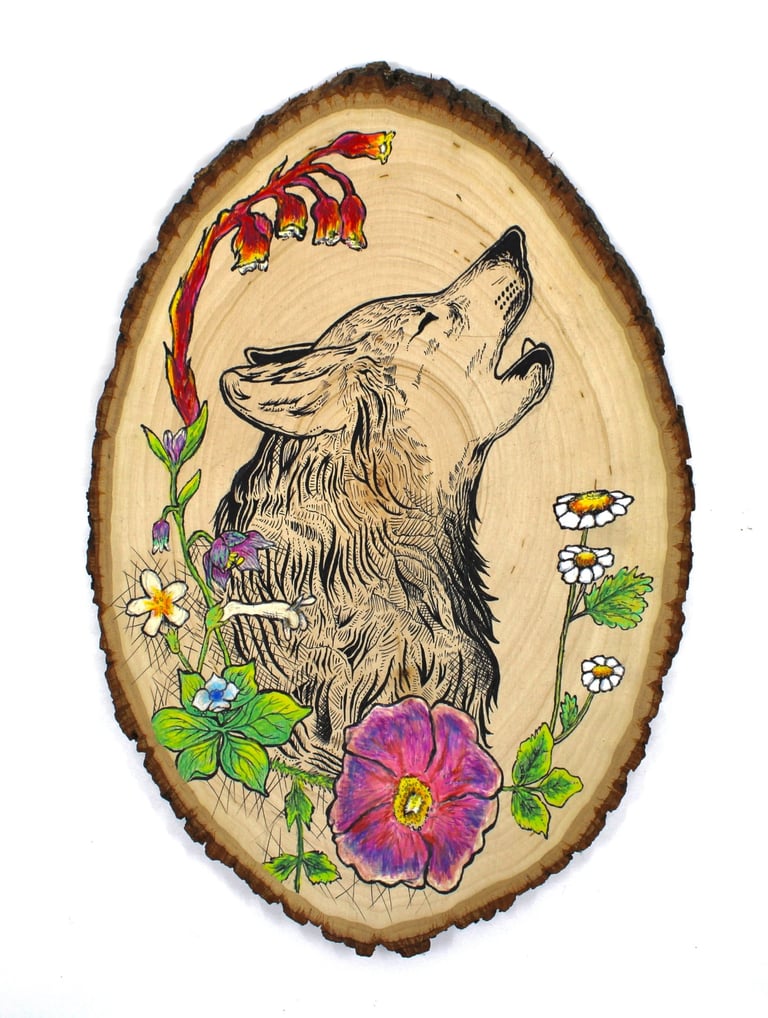 a drawing of a wolf and flowers on a wood slice
