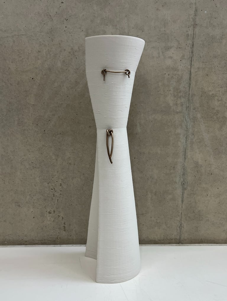 Tall & elegant ceramic vessel in 3d printed white porcelain, with bronze knot details
