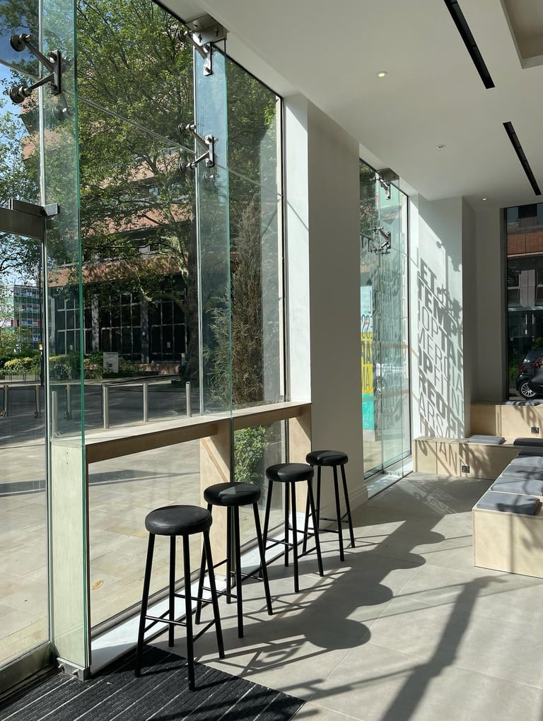 Bar seats with view from window toward Ealing borough and Dickens Yard plaza