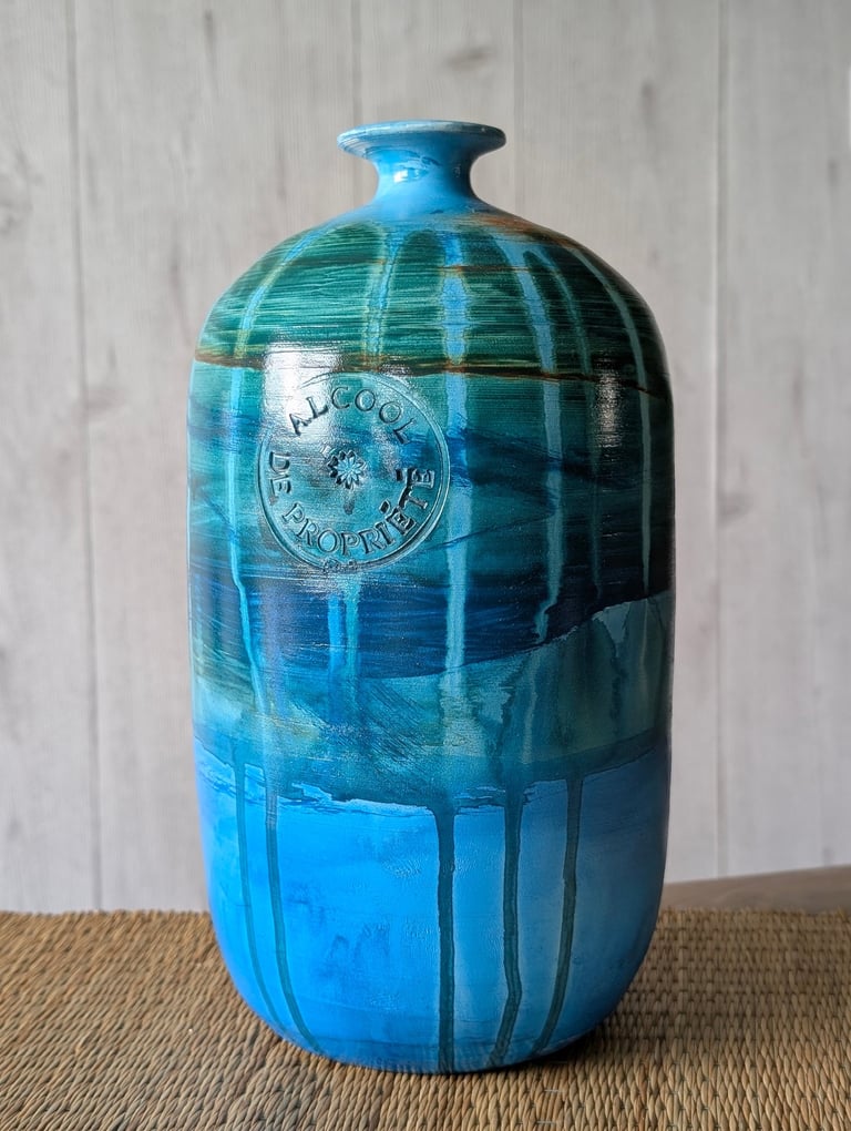 Handcrafted blue and green glazed ceramic bottle vase with rustic drip texture and embossed French stamp.