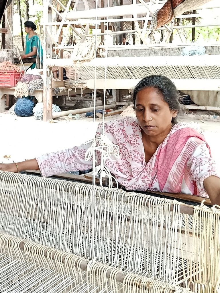 a woman is sitting on a weaving machine