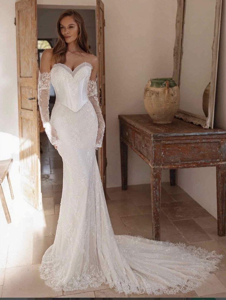 a woman in a white dress with a long sleeved dress