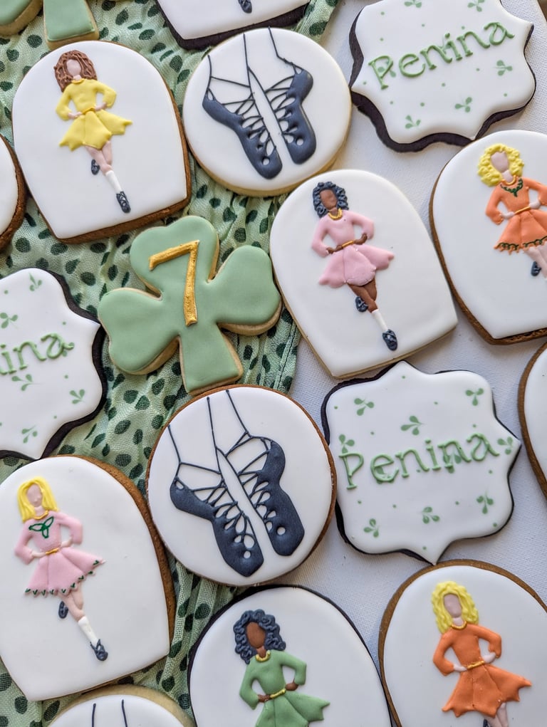 Cookies with Irish step dance theme with dancers, shoes, shamrocks in various colors