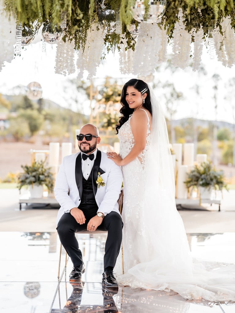 a bride and groom sitting on a chair in a wedding ceremony