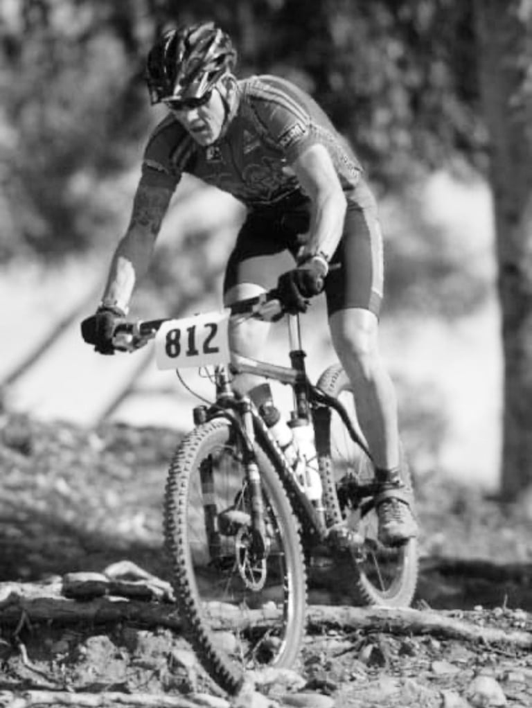 Carl Gregory  is in a mountain bike race. Black and white picture